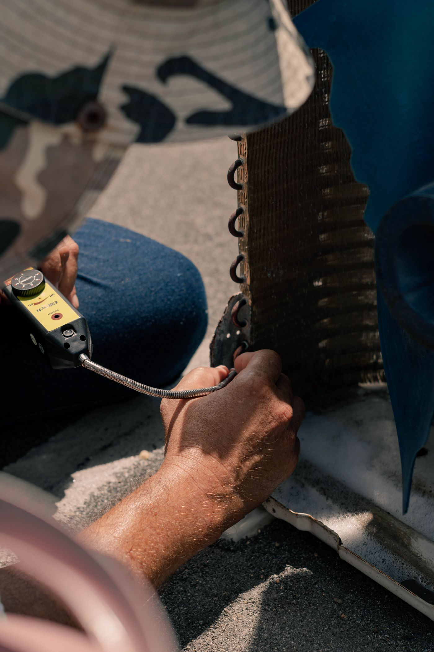 Technician testing an air conditioning system component